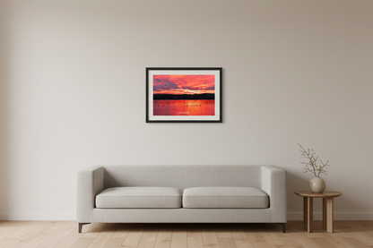 Small fine art landscape print of vivid magenta sunrise with geese silhouettes over Lake Leelanau on Veterans Day 2023 displayed in modern living room