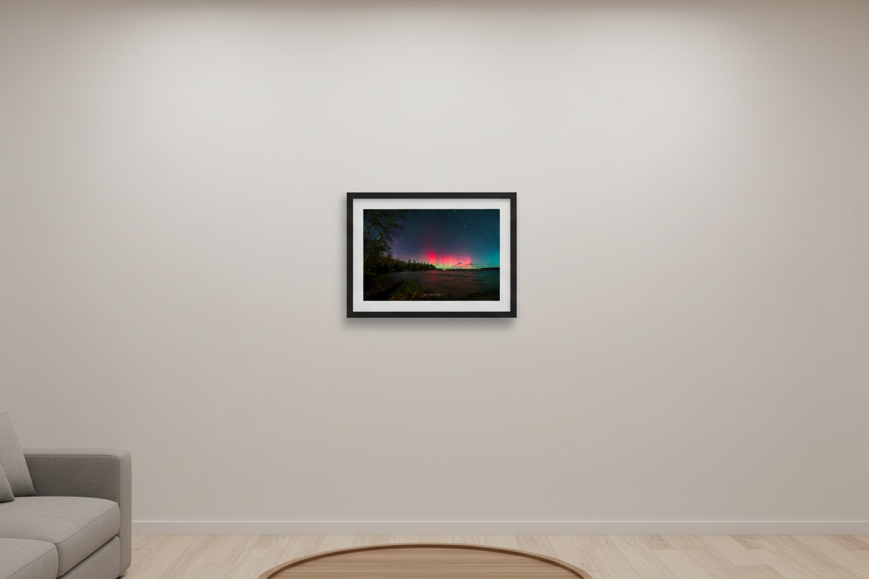 Small fine art print of vivid crimson red aurora pillars with yellow-green spike rising over Lake Leelanau wooded shoreline from Leland Michigan November 8 2024 8:33pm displayed in modern living room