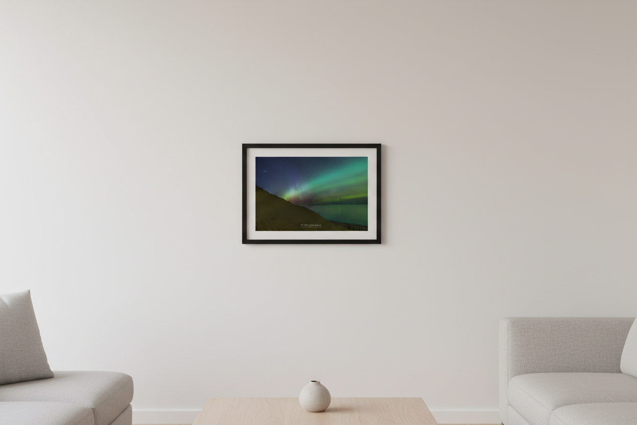 Small fine art landscape print of green and pink red aurora borealis over rippled sand dunes and calm Lake Michigan at Sleeping Bear Point Sleeping Bear Dunes Michigan March 23 2023 displayed in modern living room