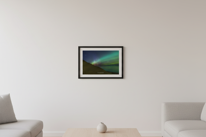Small fine art landscape print of green and pink red aurora borealis over rippled sand dunes and calm Lake Michigan at Sleeping Bear Point Sleeping Bear Dunes Michigan March 23 2023 displayed in modern living room