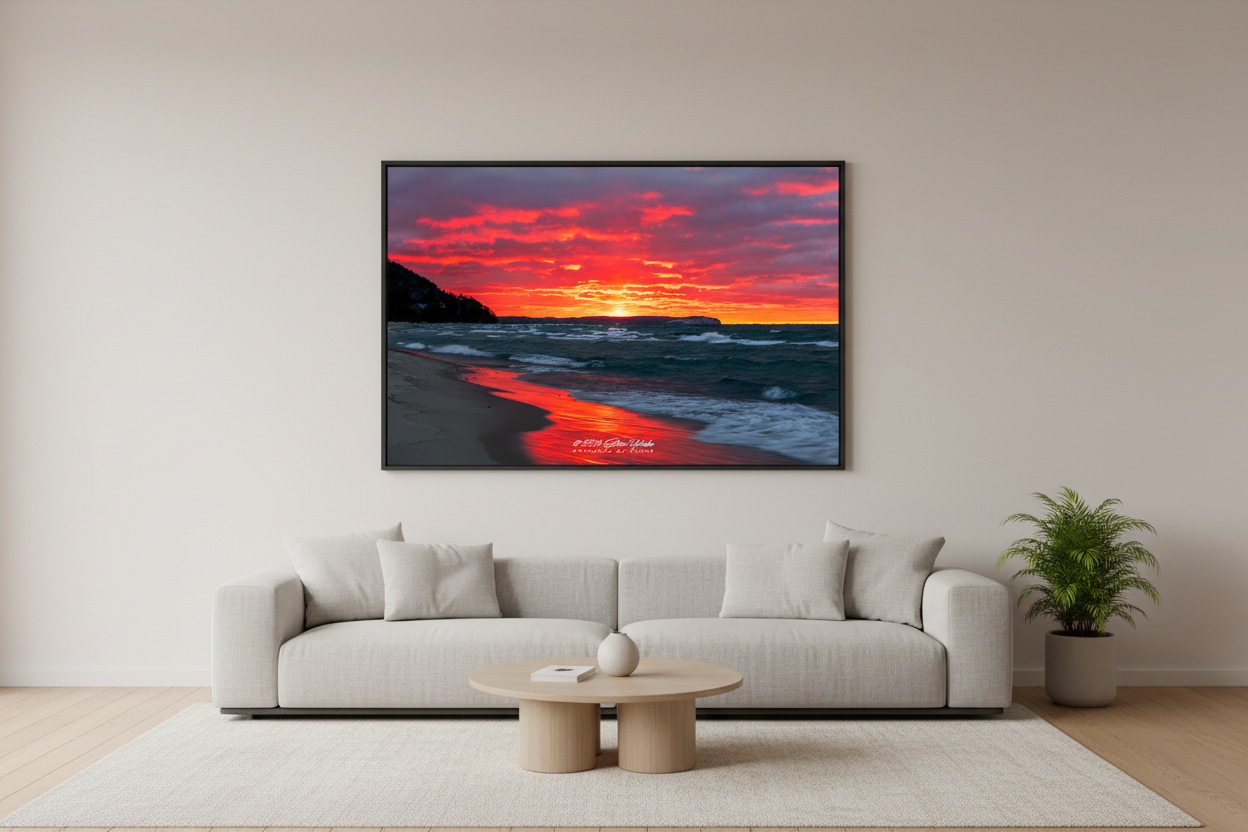 Large fine art landscape print of explosive crimson orange sun pillar sunset with churning waves and wet sand reflections on Lake Michigan beach Leland Michigan November 2024 displayed in modern living room