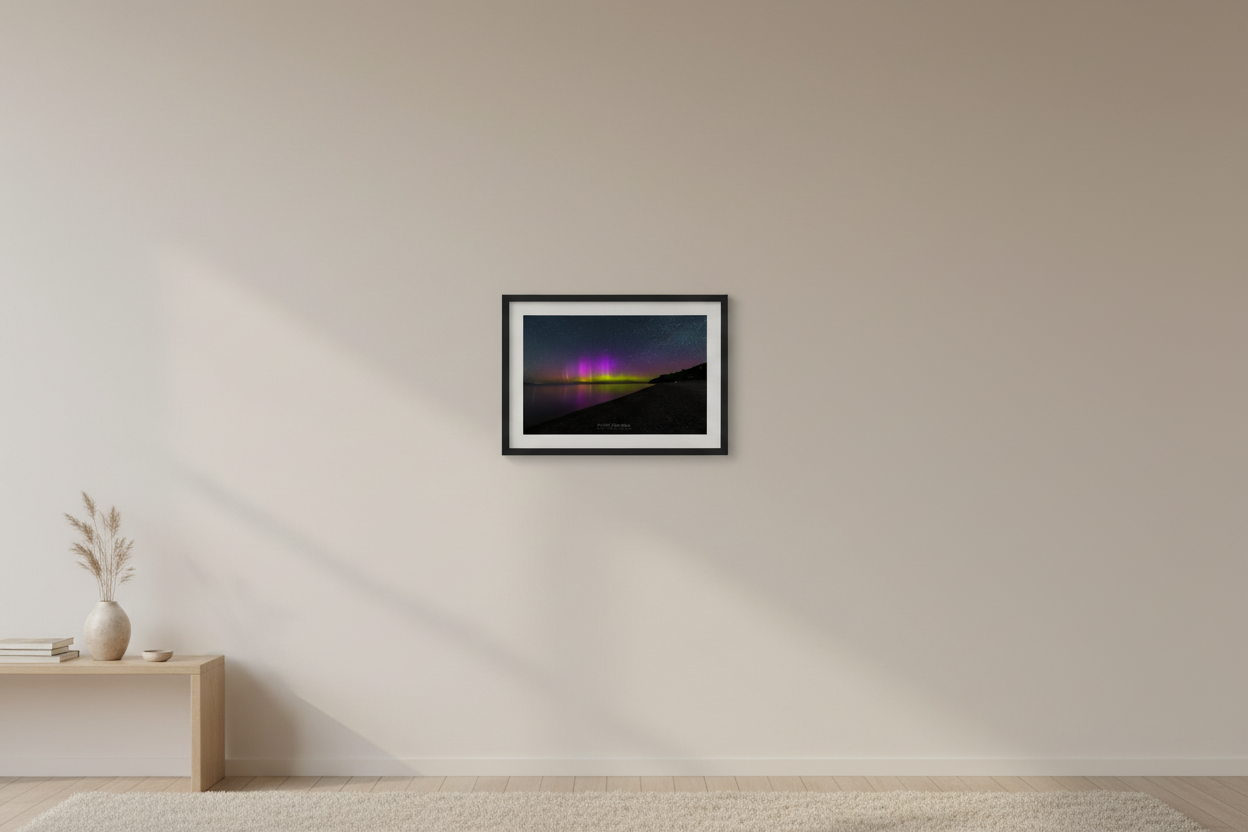 Small fine art landscape print of vivid purple magenta and yellow-green aurora borealis pillars over Lake Michigan from North Street Beach Leland Michigan May 31 2024 displayed in modern living room