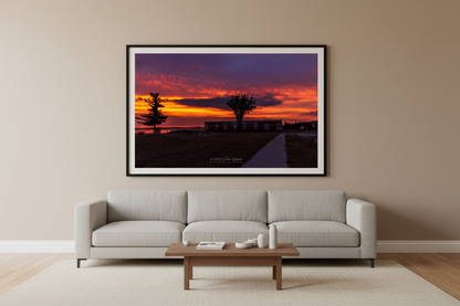 Large fine art landscape print of fiery sunrise over Glen Haven Canning Co building Sleeping Bear Dunes Michigan displayed in modern living room