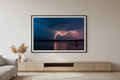 Large fine art landscape print of double lightning strike over Lake Leelanau from Leland Michigan displayed in modern living room