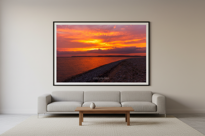Large fine art landscape print of peaceful orange sunrise over Sleeping Bear Bay from Sleeping Bear Point Michigan displayed in modern living room