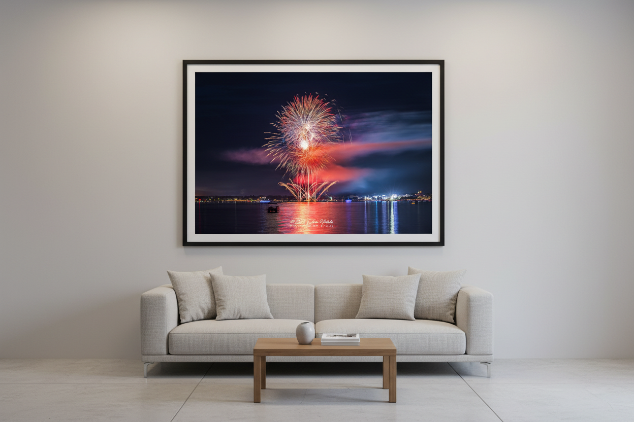 Large fine art landscape print of Traverse City 4th of July 2024 fireworks with dramatic pink smoke cloud and symmetrical golden mortar fans over Grand Traverse Bay displayed in modern living room