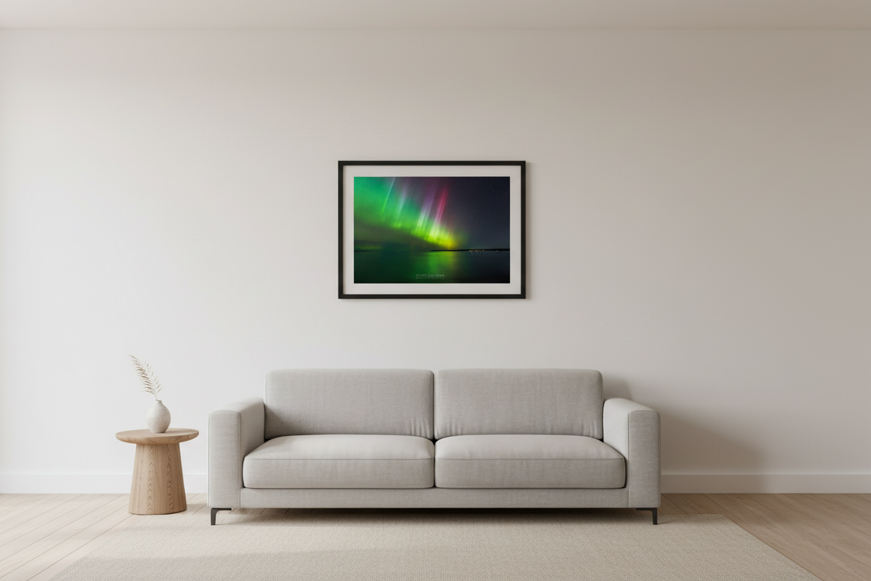 Small fine art landscape print of dramatic green yellow and magenta aurora pillars over the Manitou Passage in Lake Michigan at Sleeping Bear Dunes Michigan March 23 2023 displayed in modern living room