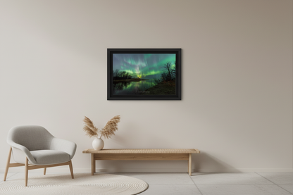 Small fine art landscape print of dramatic sweeping green aurora curtains bursting across the sky reflected in the calm Misery River with bare trees silhouetted and warm moonrise glow on the horizon Michigan Upper Peninsula April 24 2023 at 1:00am displayed in modern living room
