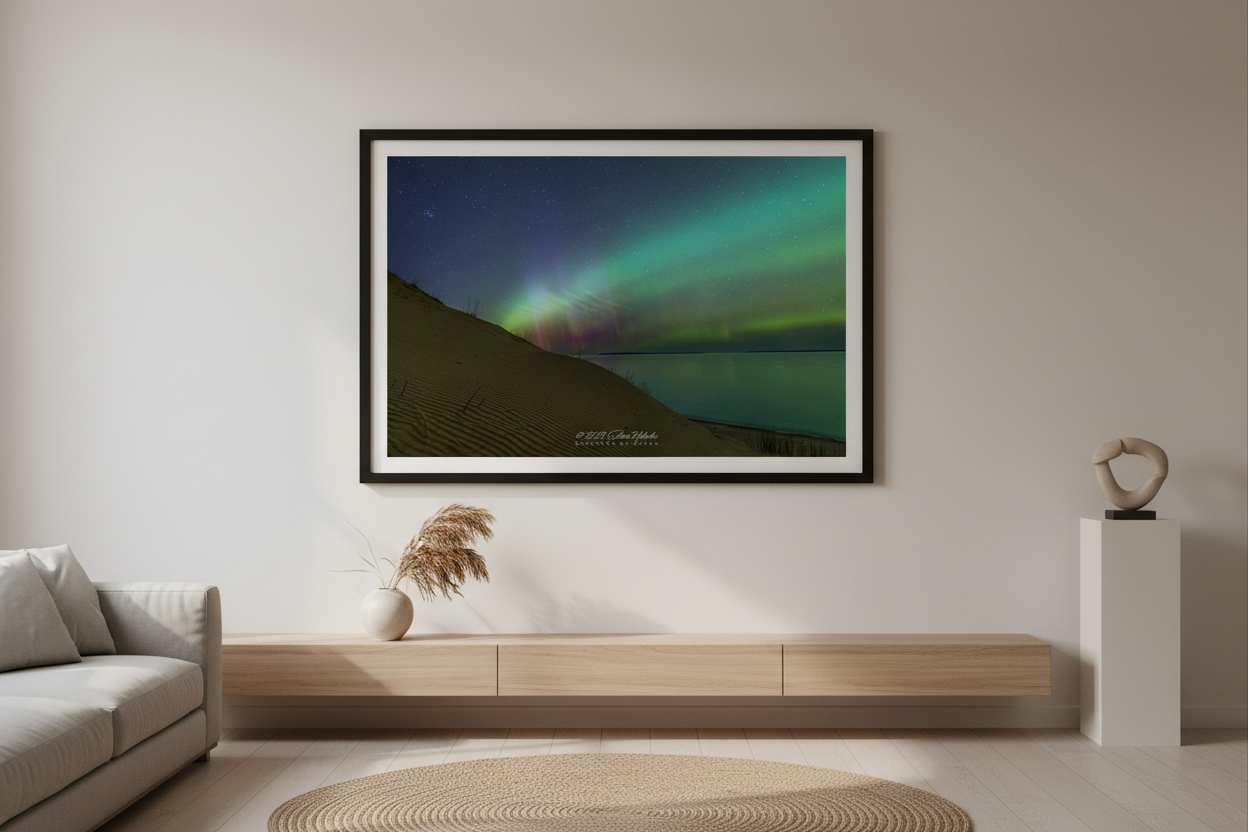 Large fine art landscape print of green and pink red aurora borealis over rippled sand dunes and calm Lake Michigan at Sleeping Bear Point Sleeping Bear Dunes Michigan March 23 2023 displayed in modern living room