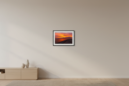 Small fine art landscape print of peaceful orange sunrise over Sleeping Bear Bay from Sleeping Bear Point Michigan displayed in modern living room