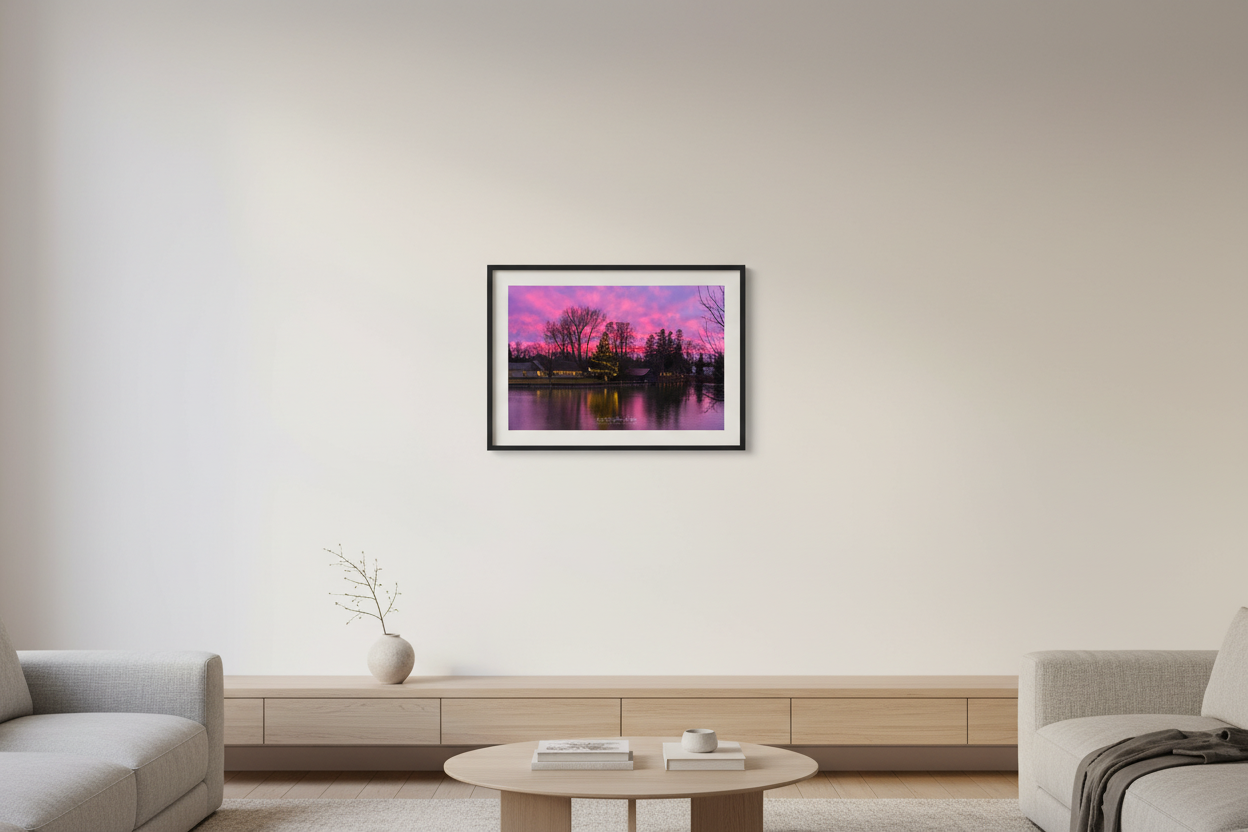 Small fine art landscape print of Christmas sunset over Leland River with lit tree and pink sky displayed in modern living room