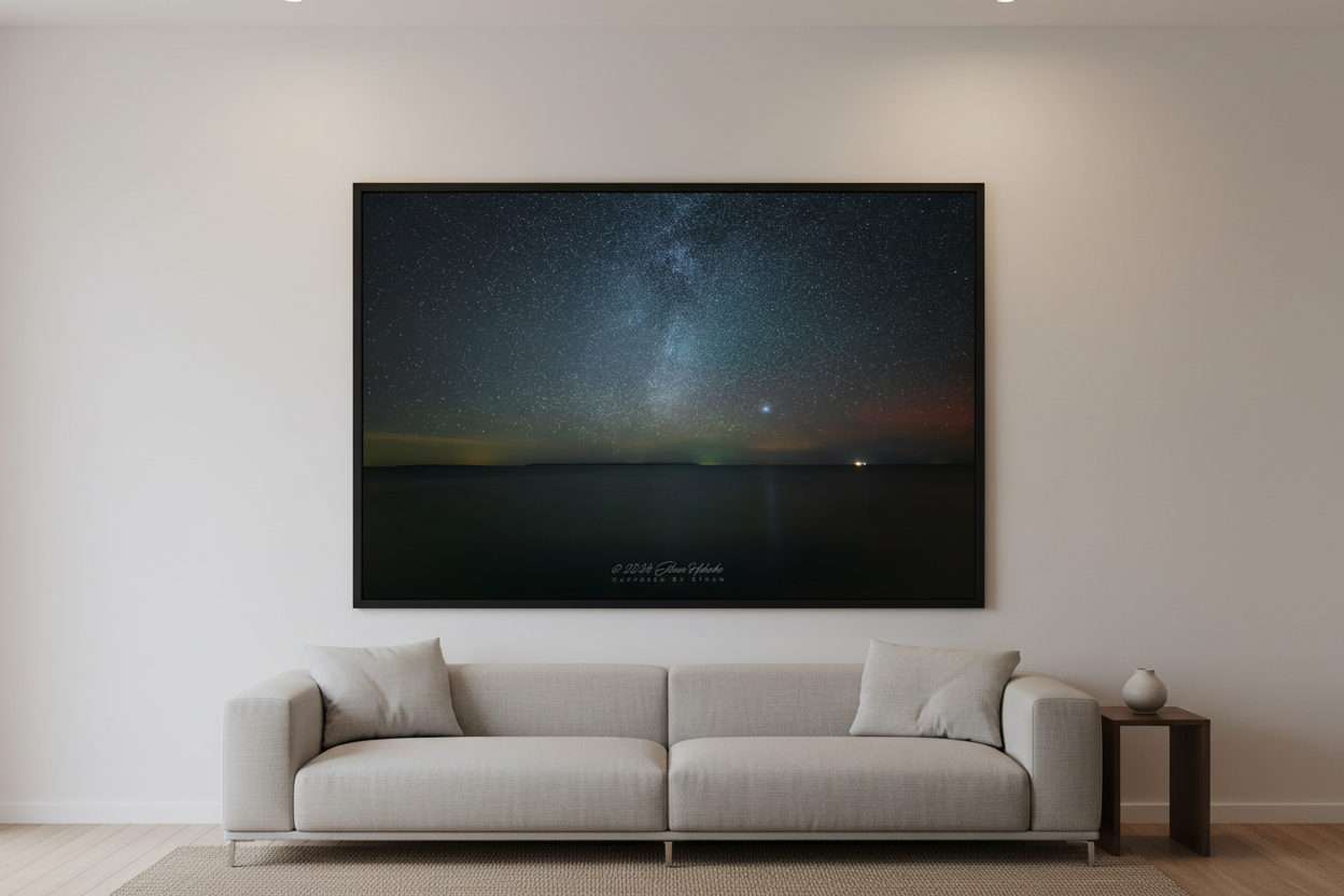 Large fine art print of Milky Way rising over Lake Michigan with North Manitou Island silhouette on horizon faint aurora glow and bright planet Leland Michigan Oct 5 2024 3:31am displayed in modern living room