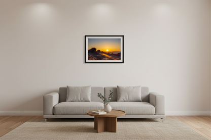 Small fine art landscape print of golden sunburst sunrise over wind-sculpted Sleeping Bear Dunes with dune grass silhouettes Michigan March 2023 displayed in modern living room