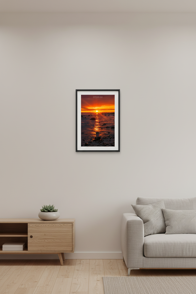 Small fine art portrait print of blazing sunrise over Grand Traverse Bay rocky shoreline from Leelanau State Park Michigan September 2023 displayed in modern living room