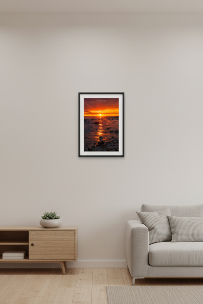 Small fine art portrait print of blazing sunrise over Grand Traverse Bay rocky shoreline from Leelanau State Park Michigan September 2023 displayed in modern living room