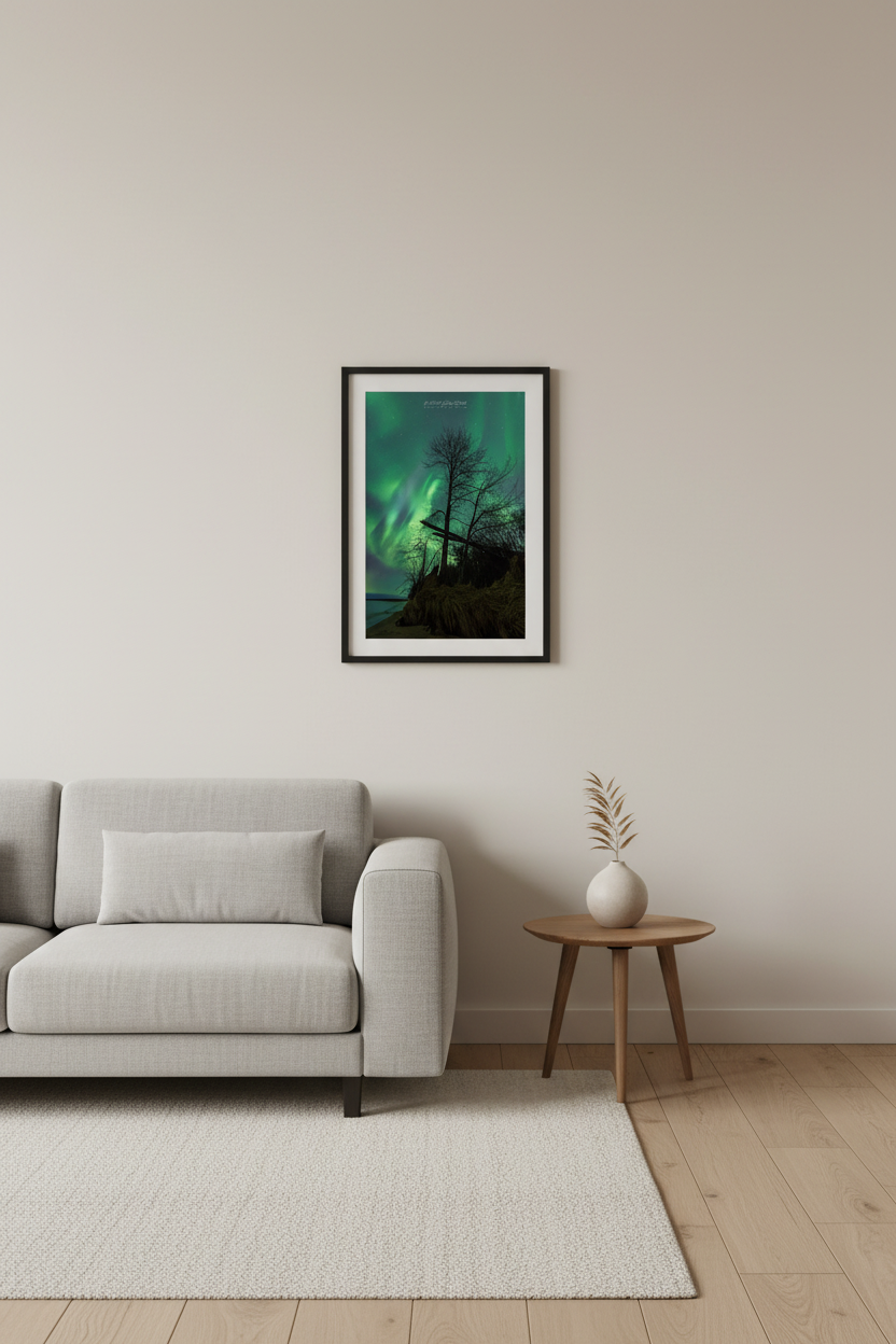 Small fine art portrait print of vivid green Northern Lights behind silhouetted bare tree and weathered wooden cross on eroding Lake Superior bluff Michigan Upper Peninsula April 23 2023 displayed in modern living room