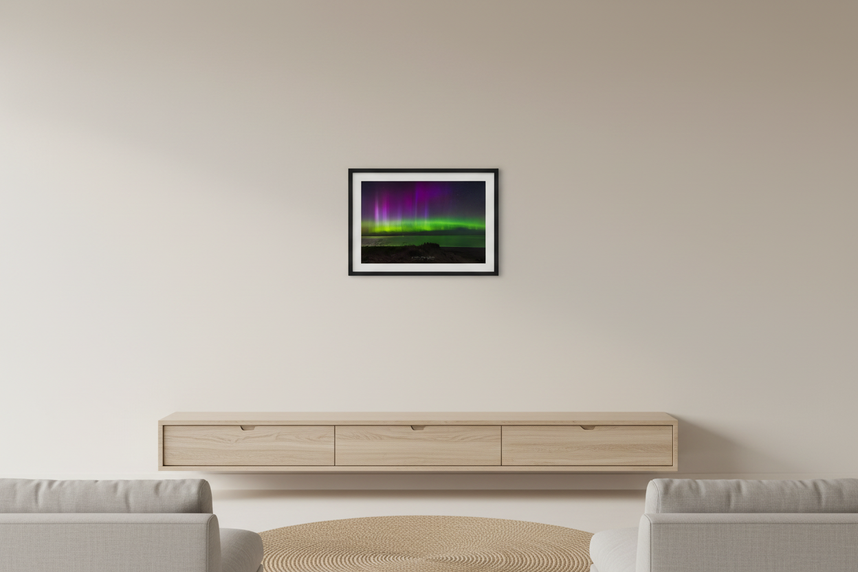 Small fine art landscape print of vivid green and purple aurora borealis pillars over Lake Michigan from Sleeping Bear Point Michigan August 11 2024 at 11:07pm with beach grass dune foreground and calm water reflection displayed in modern living room