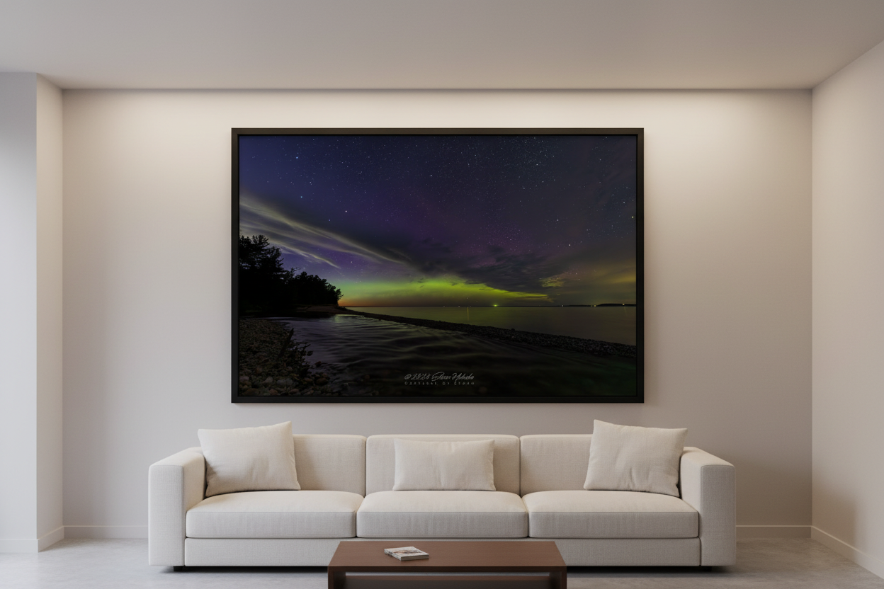Large fine art print of lime green and purple magenta Northern Lights aurora over Shalda Creek rocky shoreline with pine tree silhouette at Sleeping Bear Dunes MI displayed in modern living room