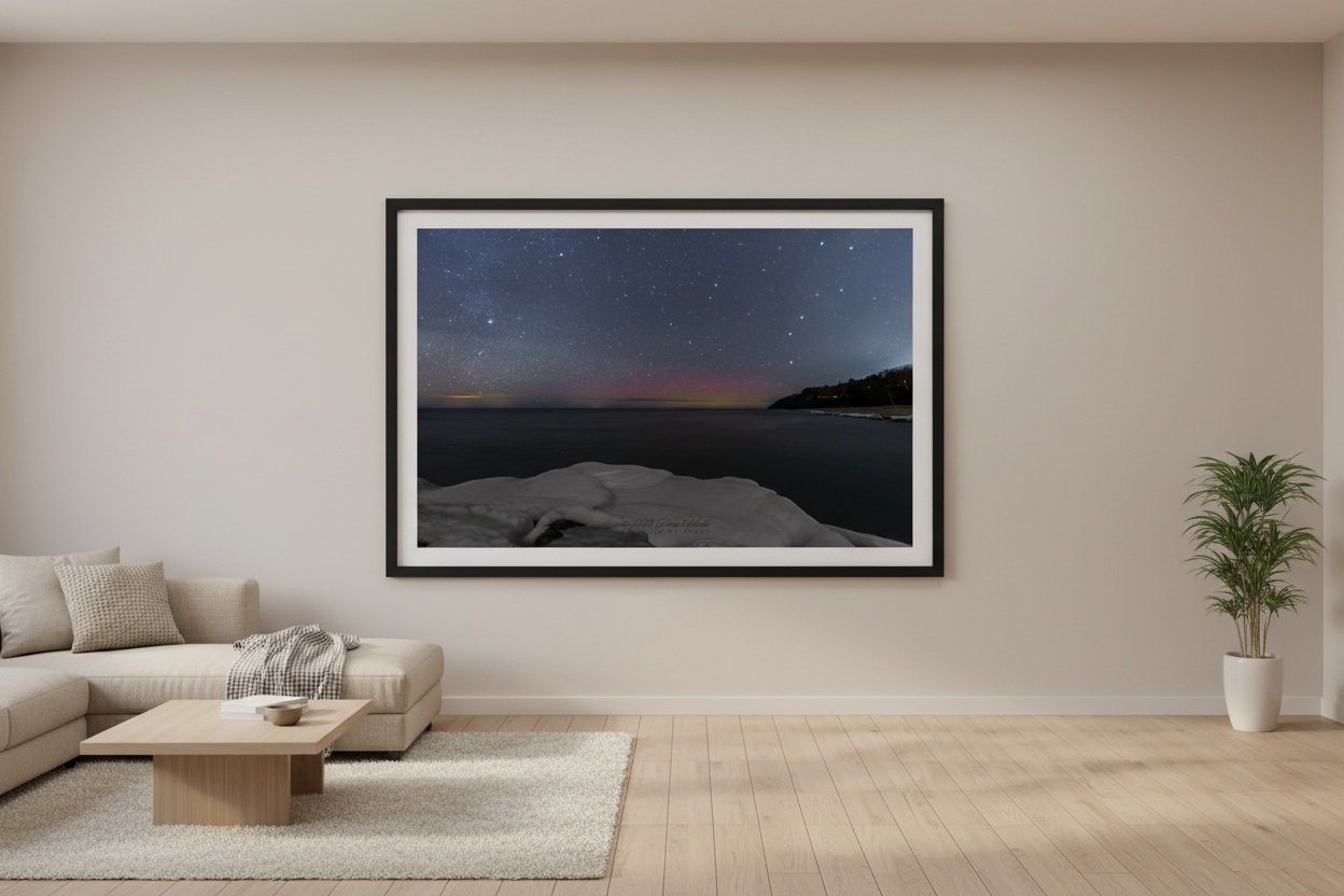 Large fine art landscape print of crimson and magenta Northern Lights aurora borealis with Big Dipper over snow and ice shoreline at North Street Beach Leland Lake Michigan February 8 2023 displayed in modern living room