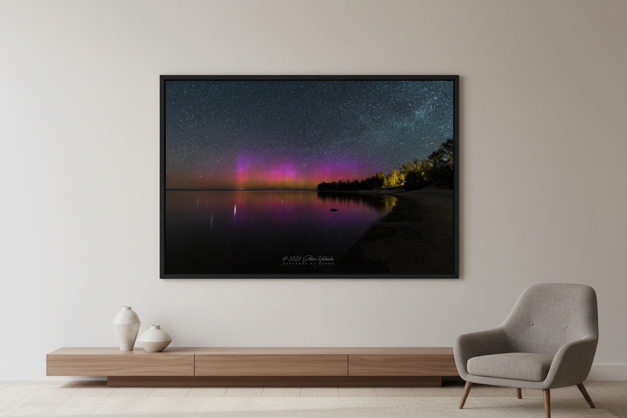 Large fine art landscape print of vivid purple and magenta Northern Lights aurora borealis pillars reflecting in calm Lake Michigan from Gills Pier Leelanau County Michigan May 6 2024 displayed in modern living room