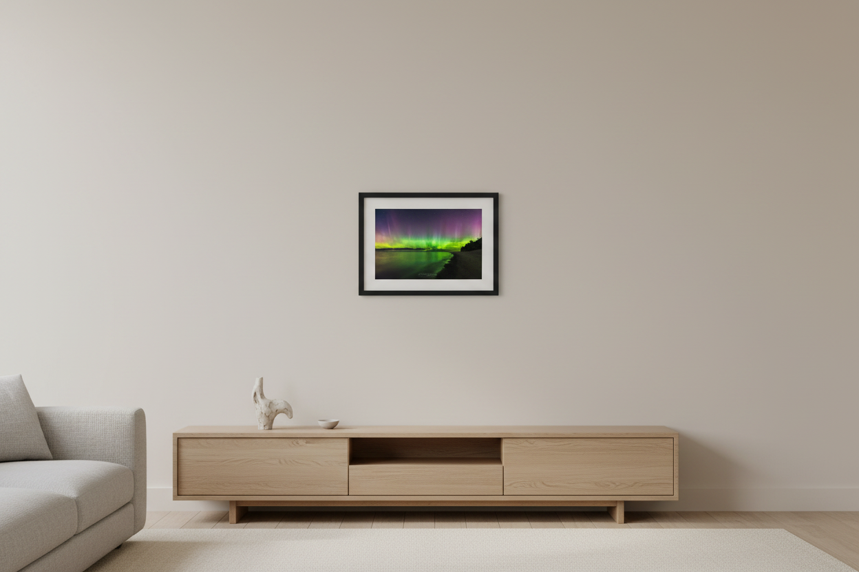 Small fine art landscape print of vivid green yellow and purple Northern Lights aurora borealis reflecting in calm Lake Michigan water at Christmas Cove Beach Northport Michigan September 18 2023 at 11:14pm displayed in modern living room