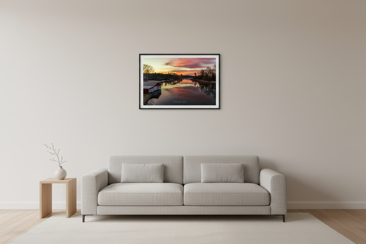 Small fine art landscape print of reflective fiery sunrise over Lake Leelanau Narrows with red boathouse Leelanau County Michigan November 2023 displayed in modern living room